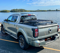 Load image into Gallery viewer, Side view of the GWM Cannon Alpha with an Akuma 4x4 Tub Rack Platform fitted and river in the background