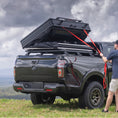 Load image into Gallery viewer, Man pulling closed Tub Rack Mounted Tent made by Akuma 4x4