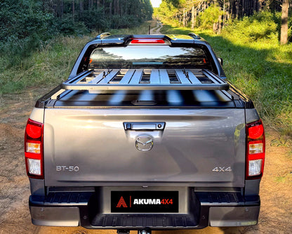 Rear view of a Akuma 4x4 Tub Rack platform fitted on to a Mazda BT-50 on a dirt road