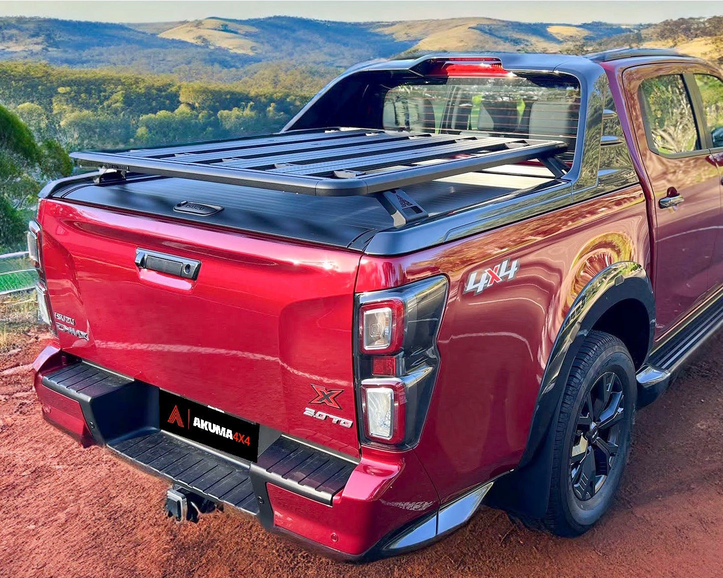 Isuzu D-Max fitted with a tub rack on roller shutter overlooking hills