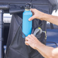 Load image into Gallery viewer, Inserting a bottle in to storage bags on Akuma 4x4 tent
