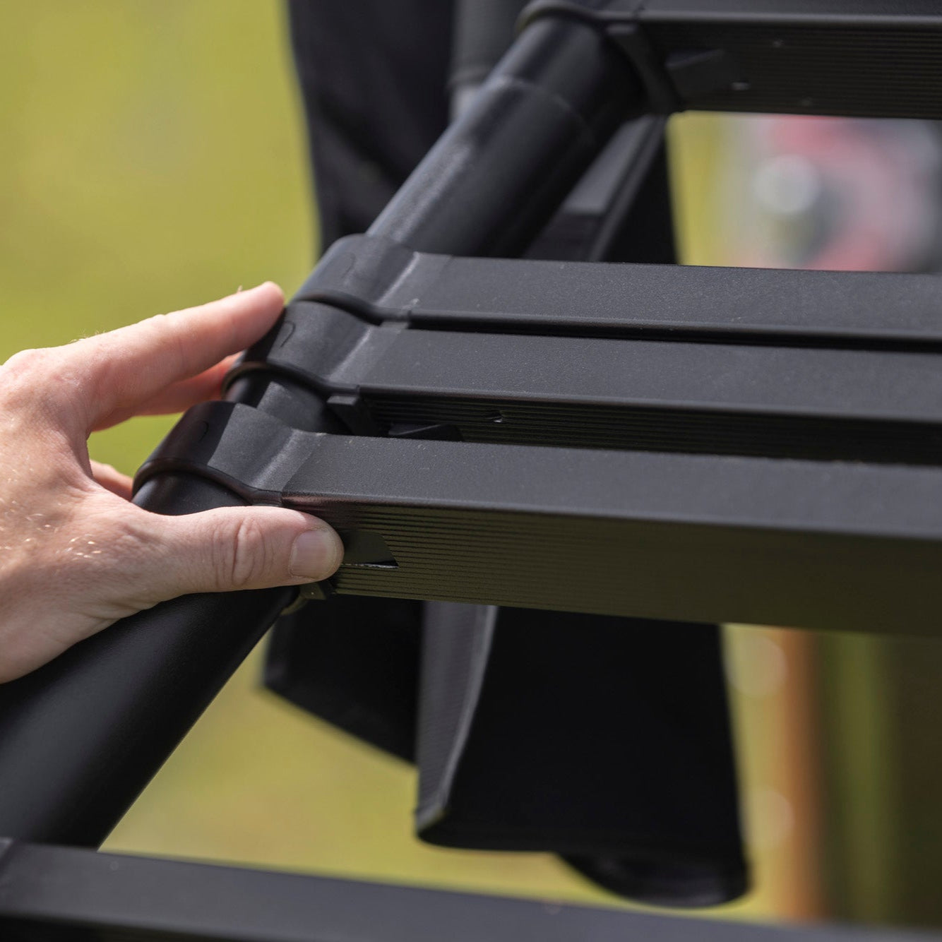 View of someone locking ladder on hardshell tent